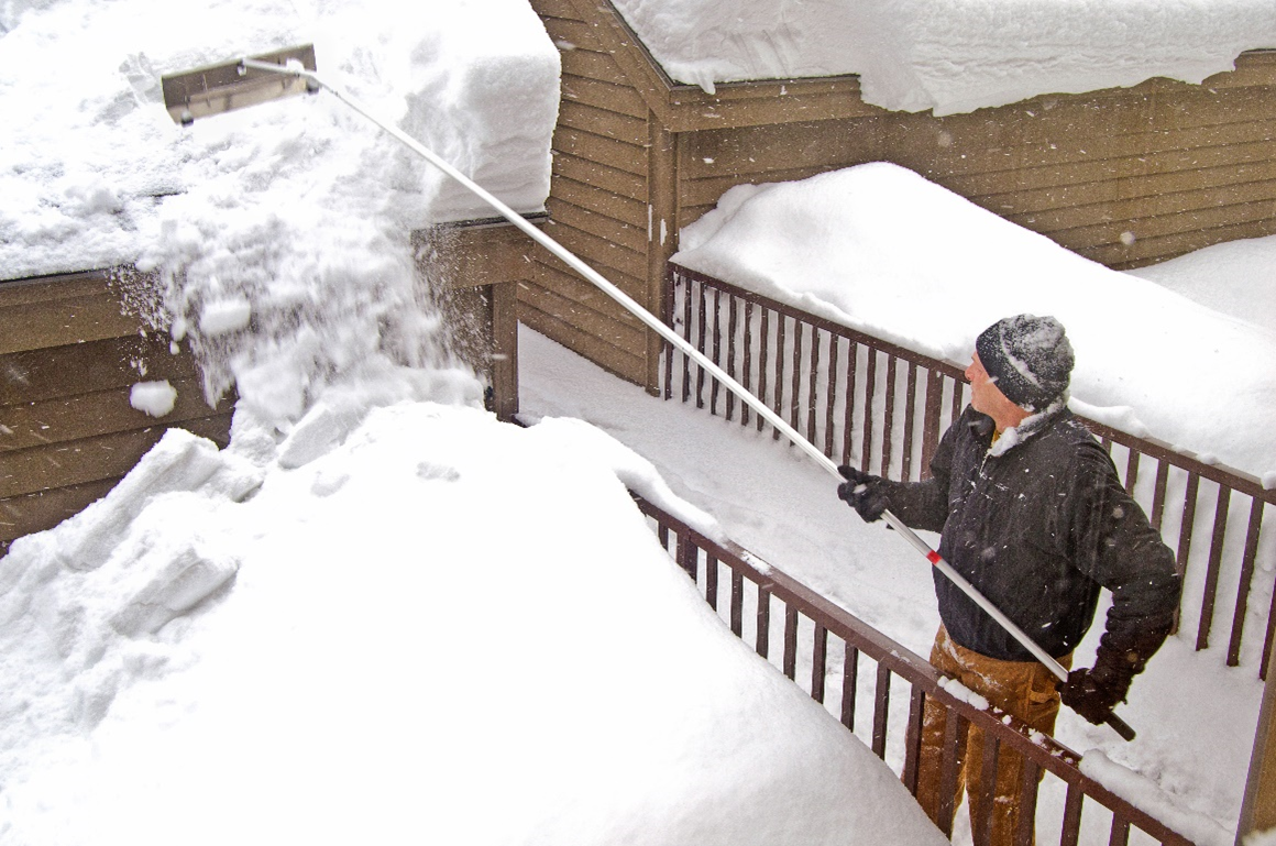 Figure 3 - Example of a roof rake being used to remove snow accumulation.