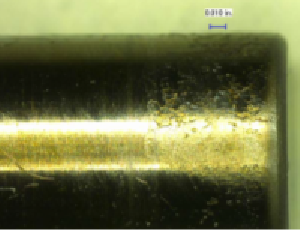 Figure 17 - Blunt end of needle valve from injector showing deposits, 50X magnification.
